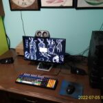 Desk workstation with monitor, keyboard, mouse, and CPU.