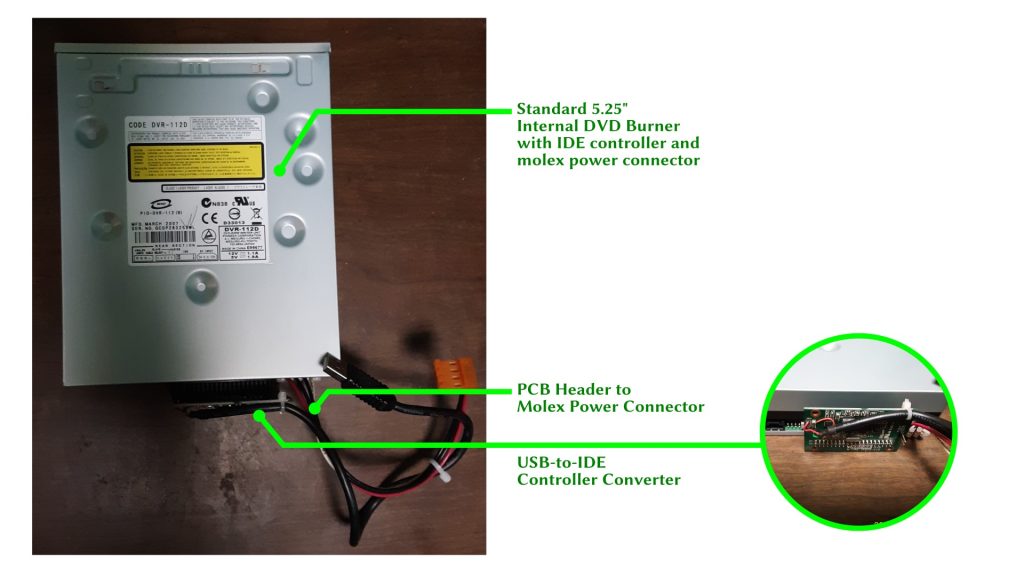 View of the DVD burner as removed, with USB and power adapter cables.