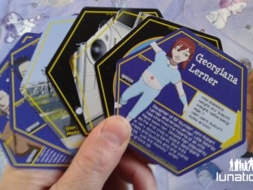 Photo of hexagonal trading cards with character info on them.