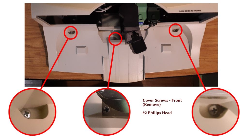 Photo of the front of the duplicator, with the door removed, showing the locations of the three screws on the front, holding the plastic shell on.
