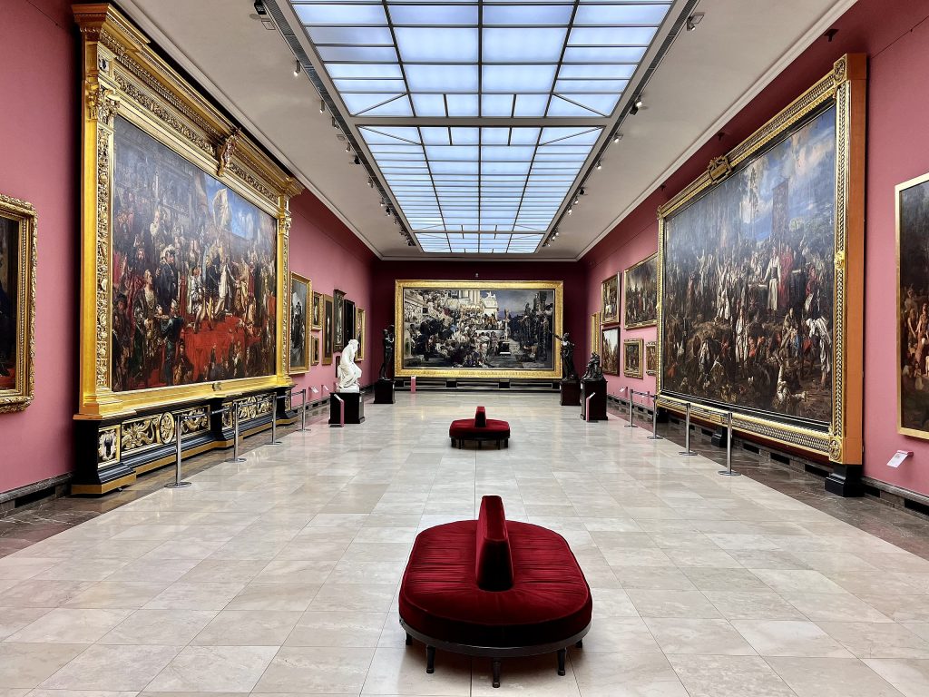 Photo of art gallery with paintings.
